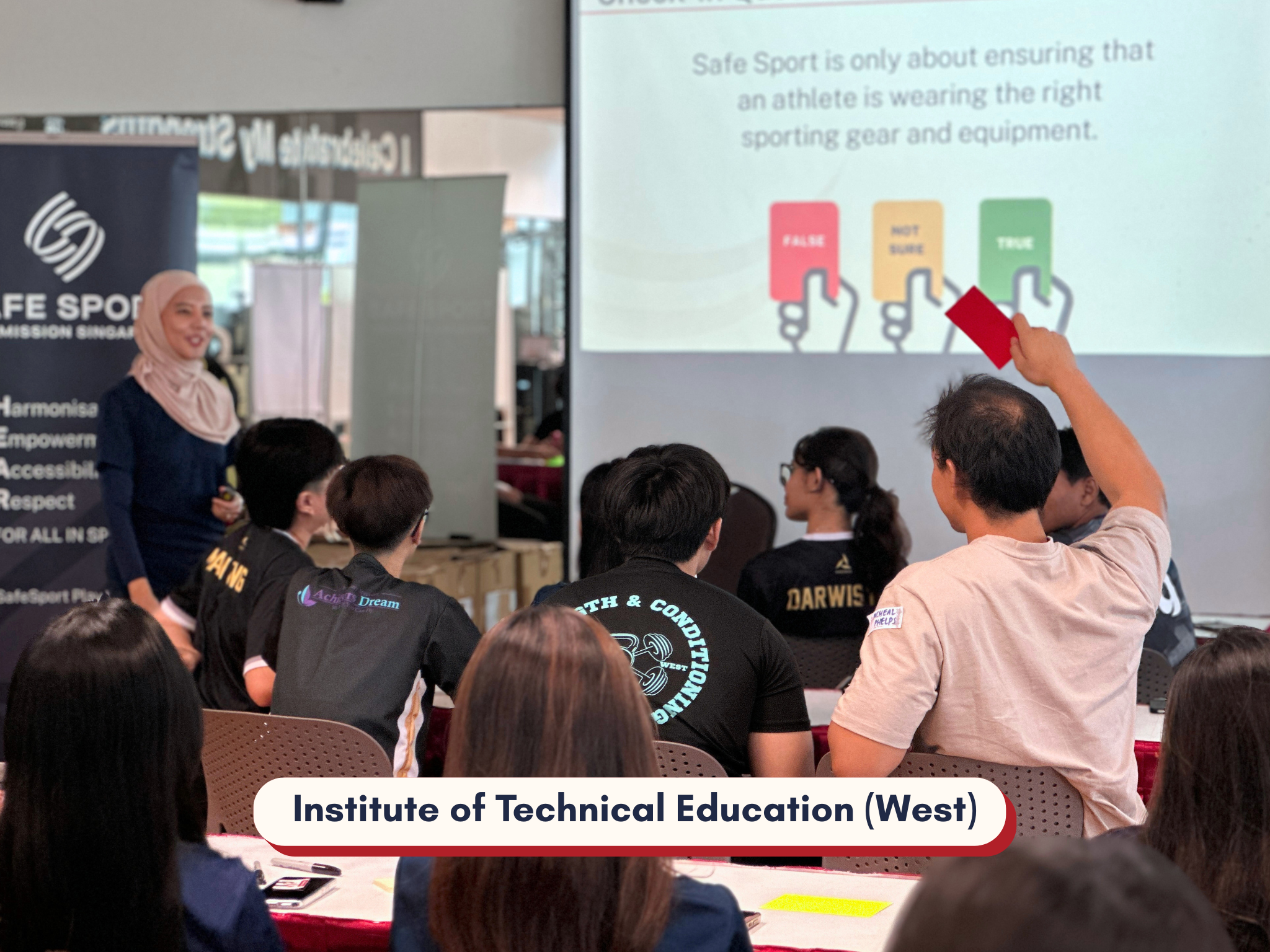 Man holding up a red card as a presenter looks at him