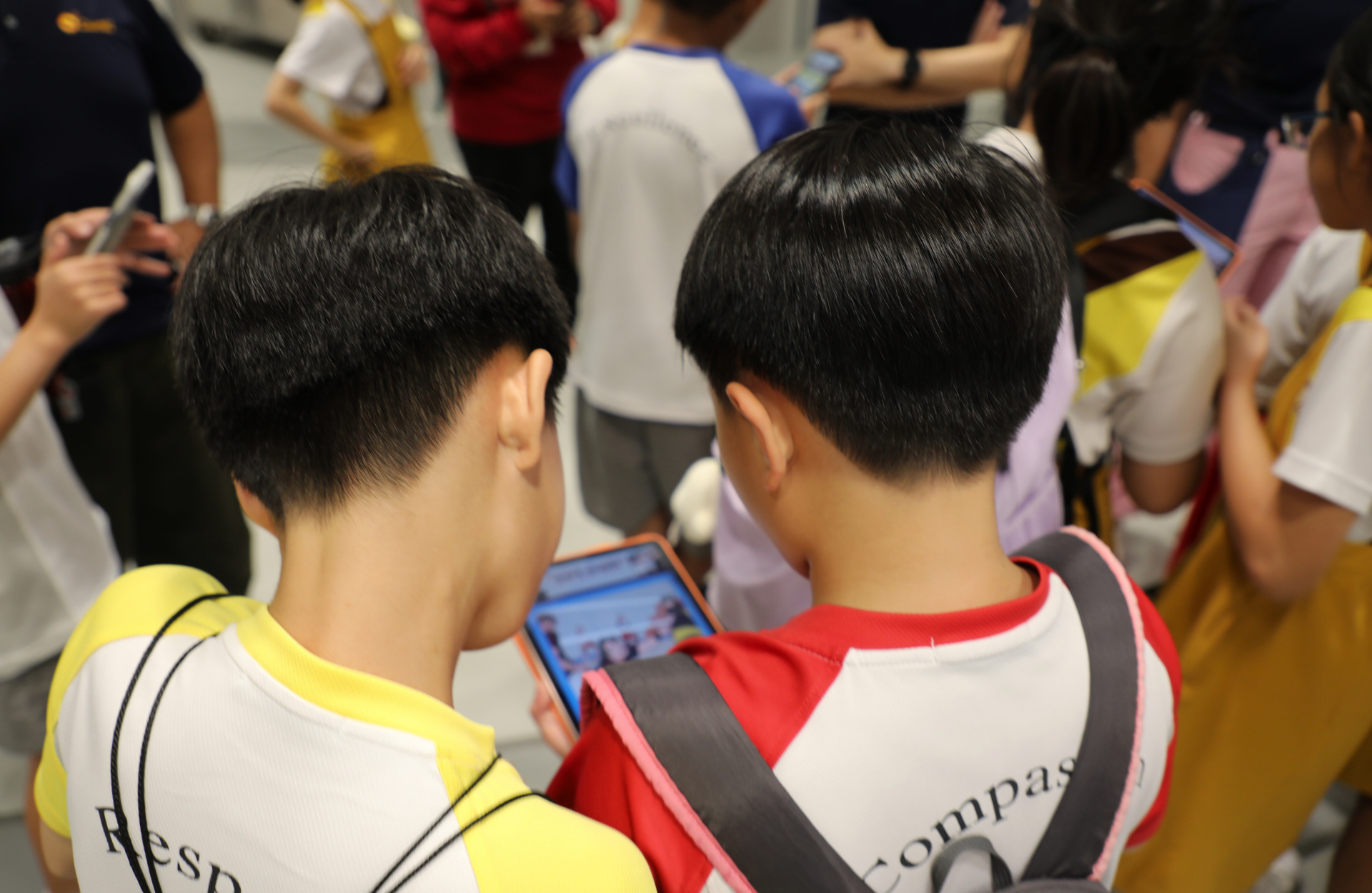 Kids using an electronic tablet to access an online game