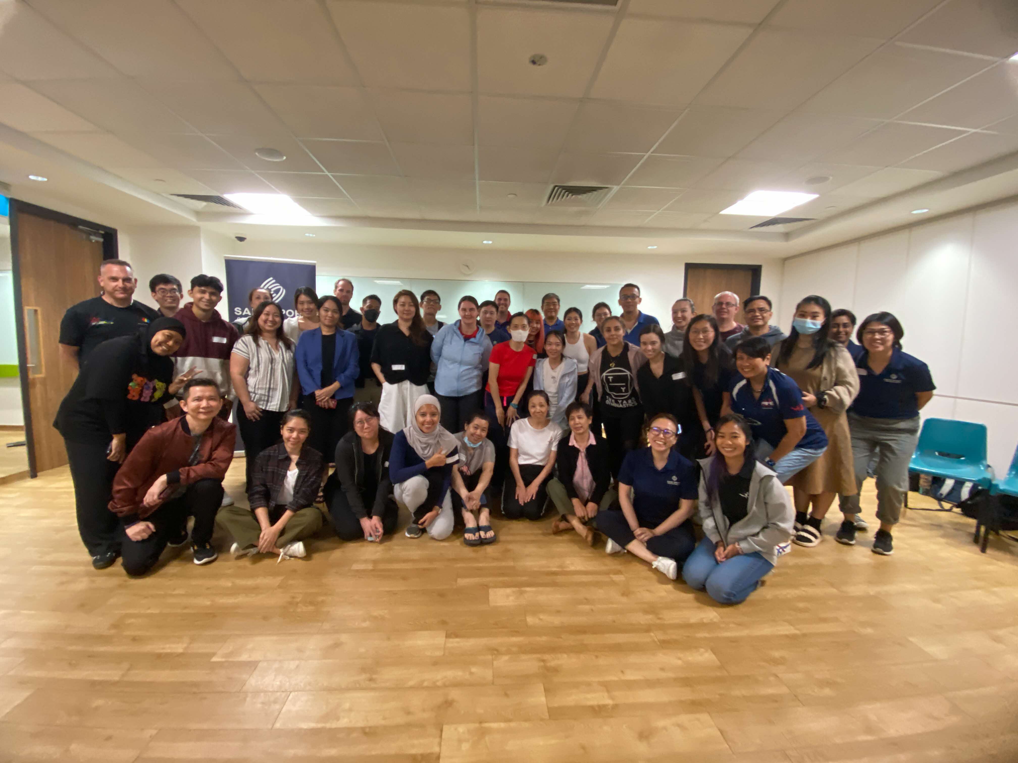 participants post for a group picture after completing the training