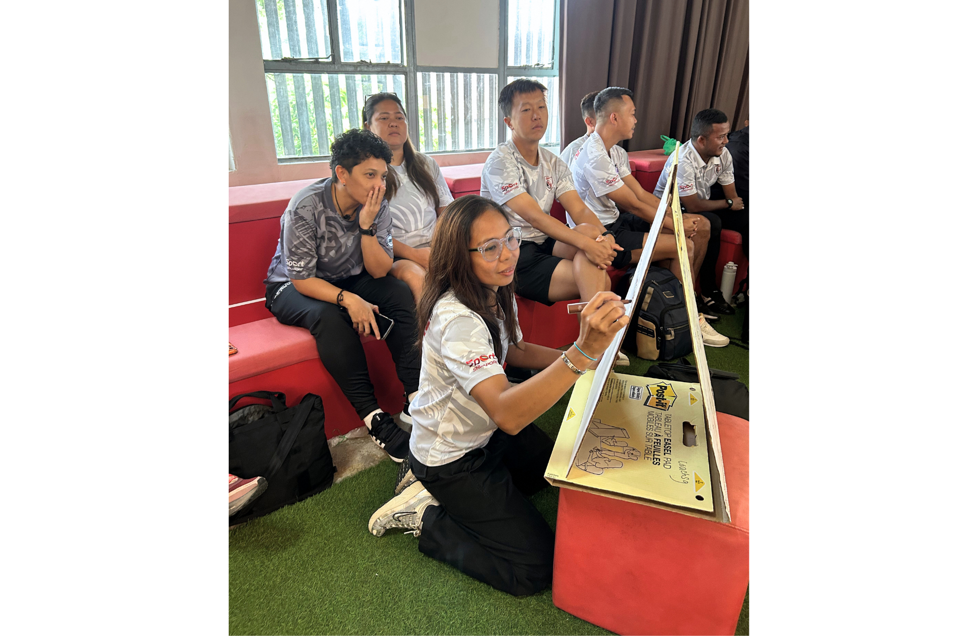 Participants writing on a flip chart