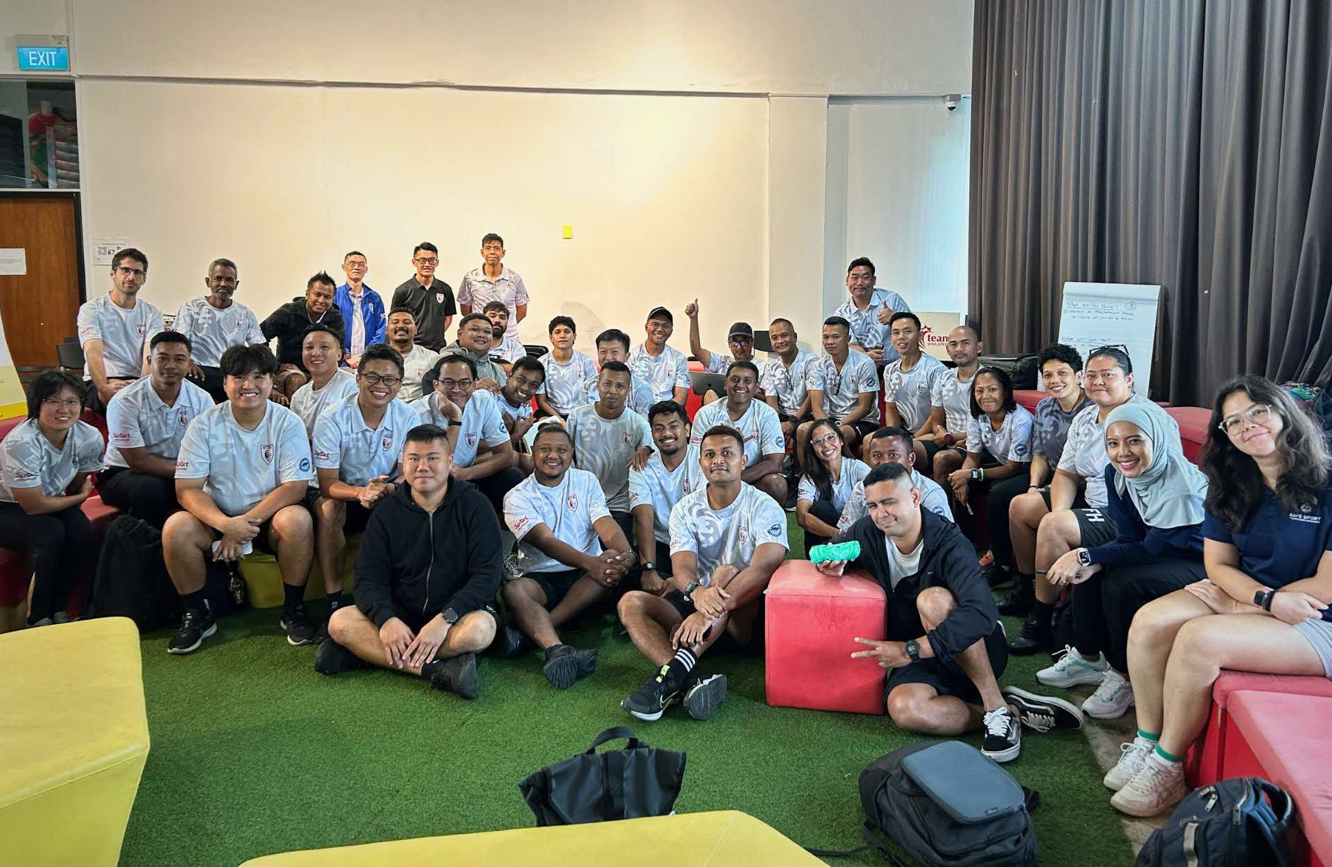 A group of people, UTR SFA coaches, gathered together