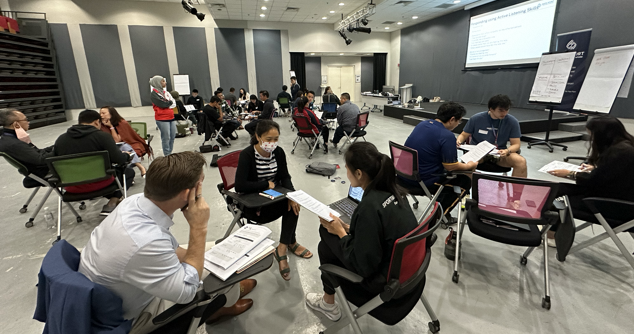 Participants engaged in small group role-play activities